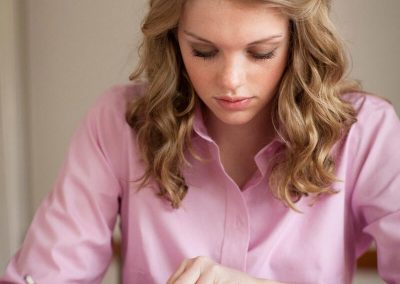 Girl writing in a journal as she studies the scriptures