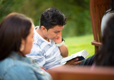 People reading their scriptures outdoors